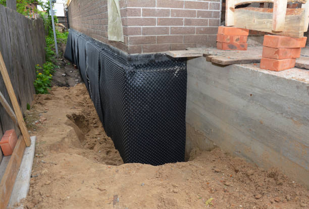 Happy homeowners after waterproofing job in Gomer